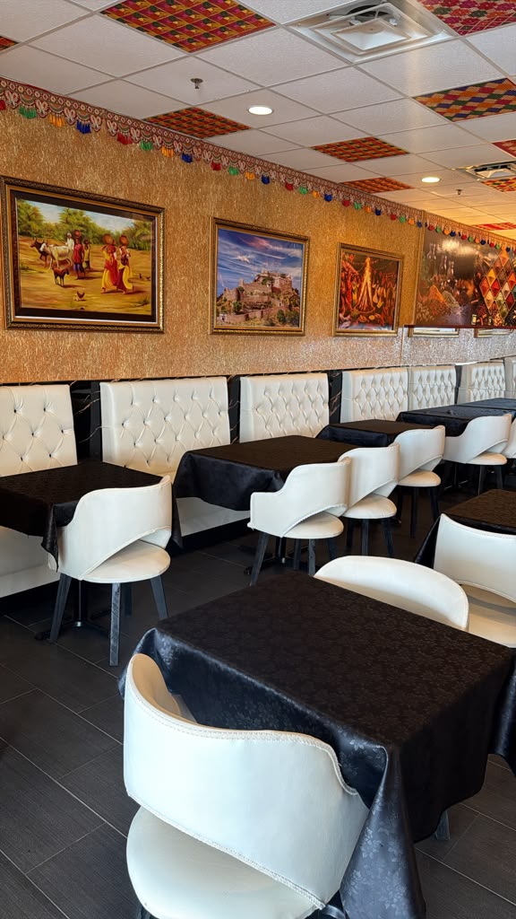 Indian Curry House dining room with tufted booths and traditional artwork